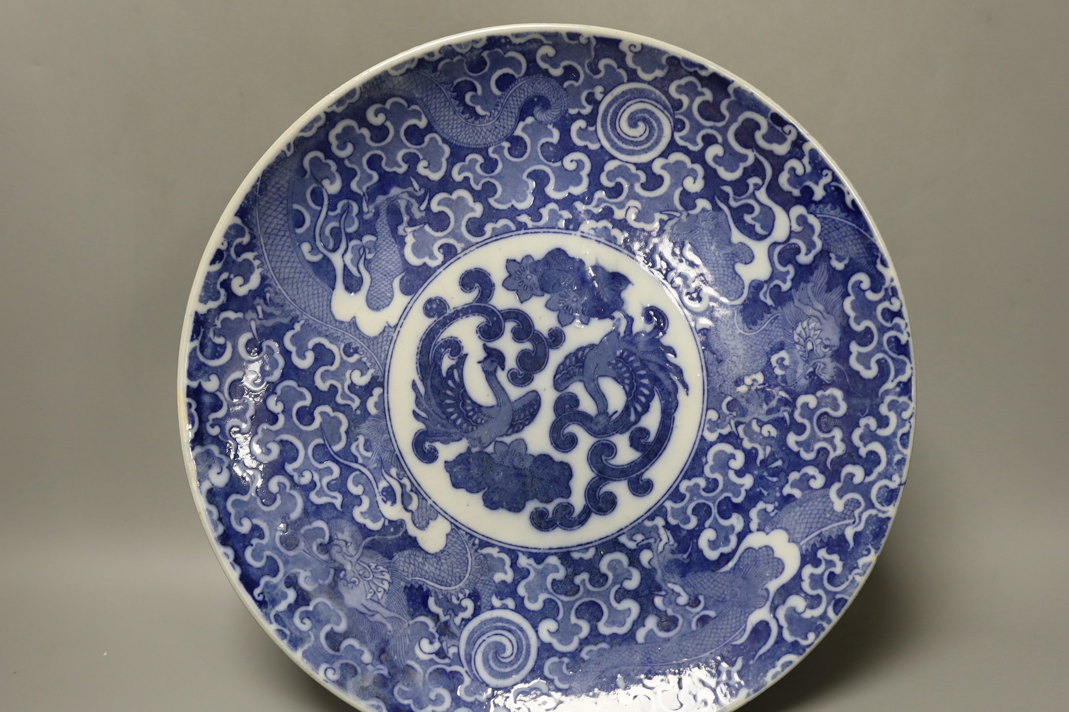 Five early 20th century Japanese blue and white dishes, largest 30.5cm diameter